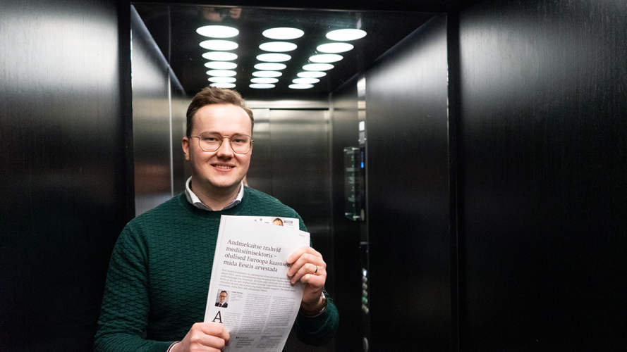 man in the elevator with newspaper